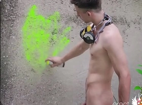 Naked teen boy with soft to hard dick draws bright graffiti outdoor