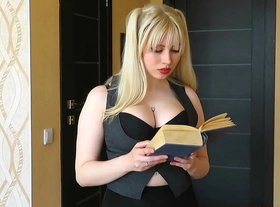 Blonde selesta is reading a book and posing in stockings and a transparent skirt